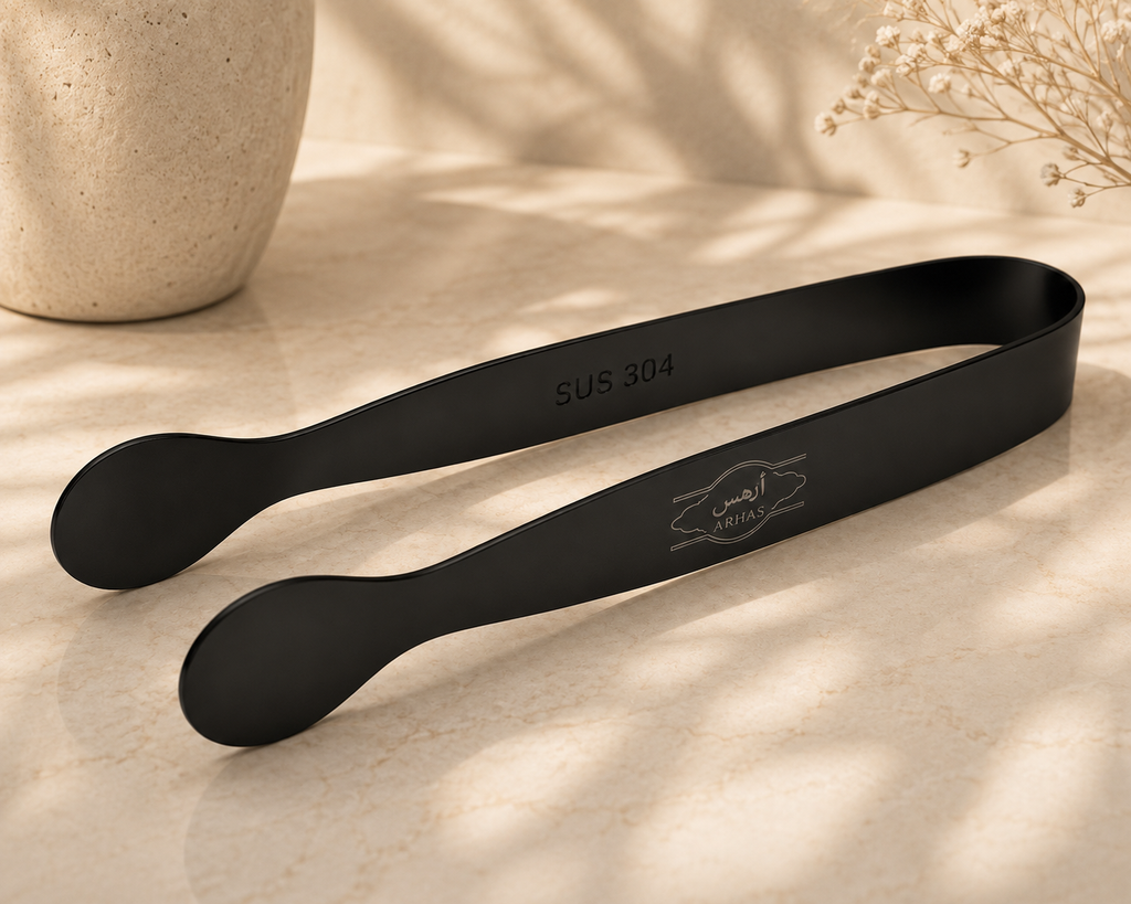 Black metal tongs with a matte finish, featuring 'SUS 304' stamped on one arm and a laser-engraved logo of two fish with the word 'MUTLA' on the other.