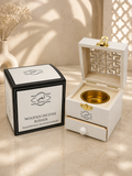 ARHAS white wooden incense burner set shown with its black-and-white branded box. The open burner has a gold-toned bowl inside, a small drawer, and a geometric cutout pattern on the inner lid.